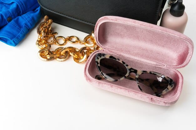 A close-up shot of a stylish woman's accessories, including designer sunglasses, a statement handbag, and layered jewelry. The focus is on the details and textures of each item, showcasing how accessories can elevate an outfit.