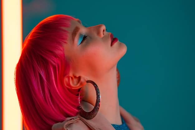 A close-up shot of a model wearing a single, oversized geometric earring in a bright, neon color, highlighting the detail and boldness of the accessory.