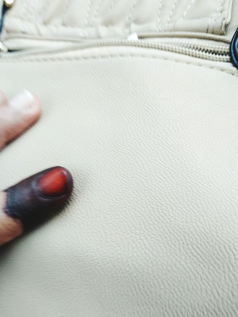 A close-up shot of a luxury handbag showing the fine leather texture, detailed stitching, and subtle branding, emphasizing the quality and craftsmanship associated with high-end Instagram style.