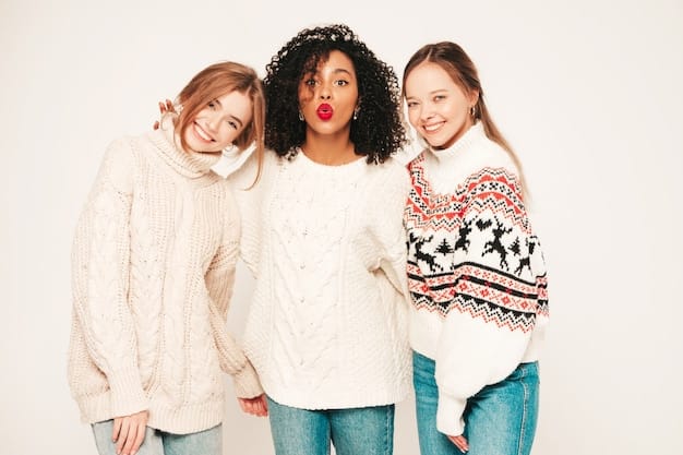 A close-up studio shot of a variety of oversized knit sweaters from Shein, showcasing different textures (cable knit, ribbed), colors (cream, mustard yellow, forest green), and patterns (fair isle, geometric). Some sweaters are accessorized with delicate necklaces.