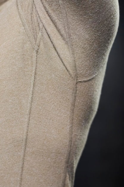 A close-up shot of various Shein activewear fabrics, showcasing different textures and patterns. The image focuses on the details of the material, such as stitching, elasticity, and breathability. Swatches of leggings, sports bras, and tops are visible.