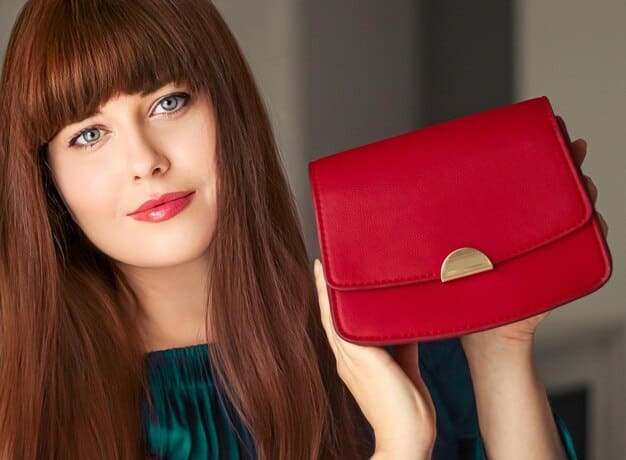 A close-up shot of a Temu handbag that closely resembles a designer brand's popular model. The image highlights the quality of the materials and craftsmanship, emphasizing the bag's stylish design and attention to detail.