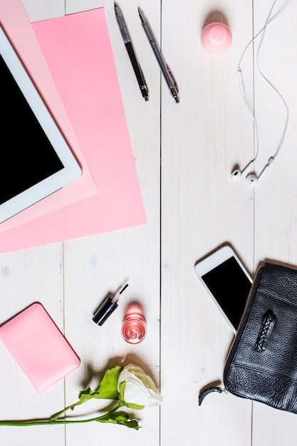 A detailed flat lay of a fashion influencer's desk, featuring a laptop displaying Instagram, a notebook with content ideas, a professional camera, and various beauty products, symbolizing content creation and strategy.