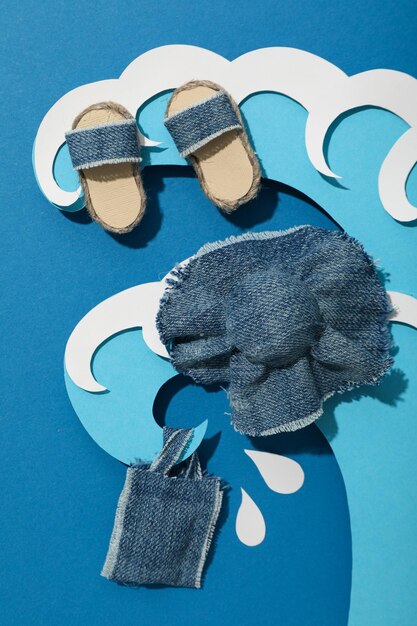 A brightly lit flat lay showcasing meticulously arranged sustainable fashion pieces: a linen shirt, repurposed denim jeans, a hand-knitted tote bag, and cork sandals, emphasizing eco-conscious style.