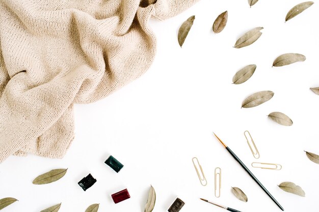 A detailed flat lay of a fashion creator's workspace, featuring a mood board with fabric swatches, sketches, a notebook with scribbled ideas, and a professional camera, symbolizing the creative process and dedication required.