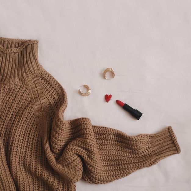 A flat lay of various Shein clothing items, including a versatile neutral-colored top, a pair of classic denim jeans, and a lightweight jacket, all neatly arranged to showcase how they could form a cohesive outfit. The items are on a light background, highlighting their textures and colors.
