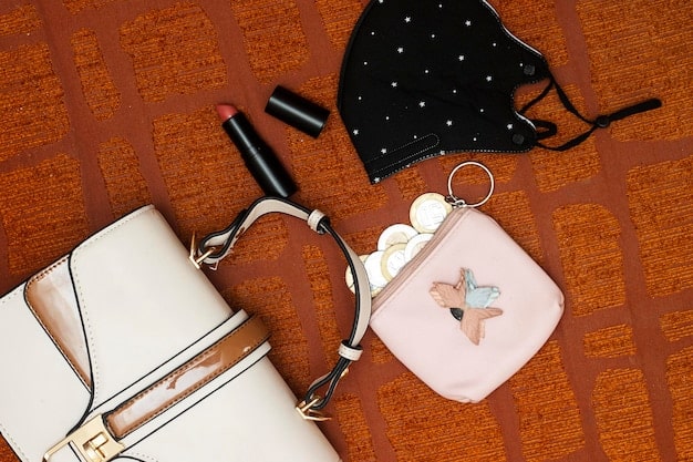 A close-up shot of a stylish outfit, highlighting key accessories like a minimalist handbag and delicate layered jewelry, all visibly within an affordable price range. The focus is on the textures of the clothing and accessories, demonstrating quality even on a budget.