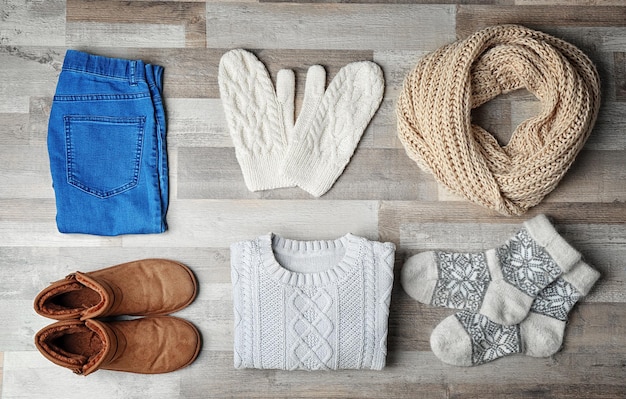 A curated Flat Lay of Shein winter-to-spring transitional clothing, including ribbed knit sets, a textured oversized cardigan, and straight-leg jeans, all in neutral tones.