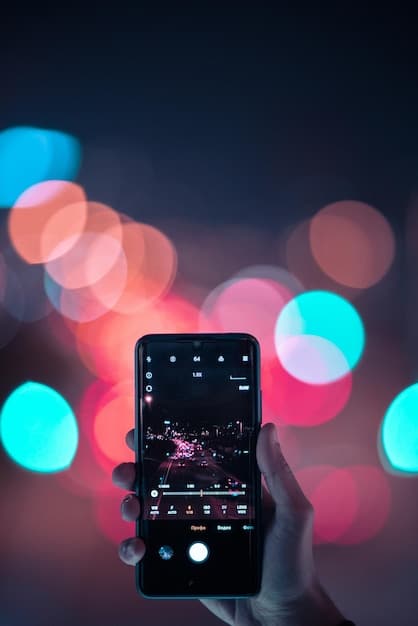 A person's hands holding a smartphone, actively editing an Instagram Reel. The screen shows options for music selection and video effects, with a vibrant but minimalist workspace background.