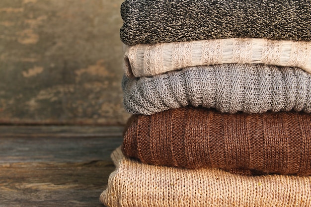 Close-up of a neatly folded stack of neutral-colored sweaters, showcasing the texture and quality of minimalist clothing. The image highlights the 'less is more' aesthetic of minimalist fashion in The 2025 Guide to Minimalist Fashion: Less is More.