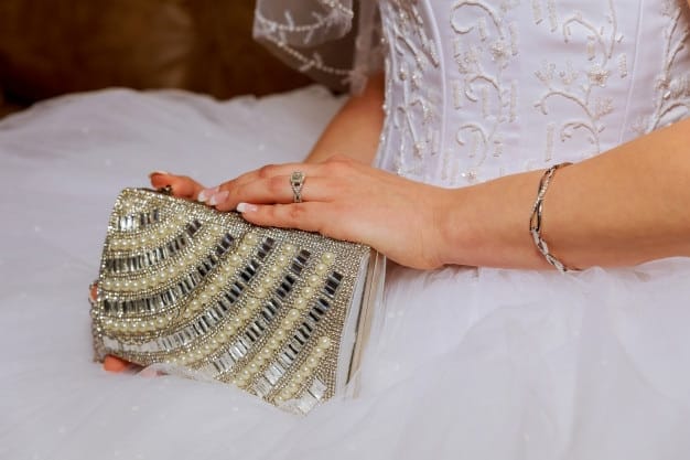 A detailed shot showcases a range of wedding guest accessories, including elegant jewelry, clutches in varying textures and colors, and stylish shoes (heels, flats, and wedges). This image emphasizes the importance of selecting the right accessories to complement and elevate a wedding guest's outfit in 2025.