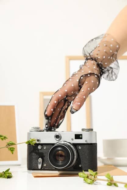 A close-up shot of a fashion influencer's hands holding a camera, focusing on the settings and dials. The background is softly blurred, highlighting the technical aspects of photography used in US Fashion Influencer Photography: Mastering Visual Storytelling for Instagram Success.