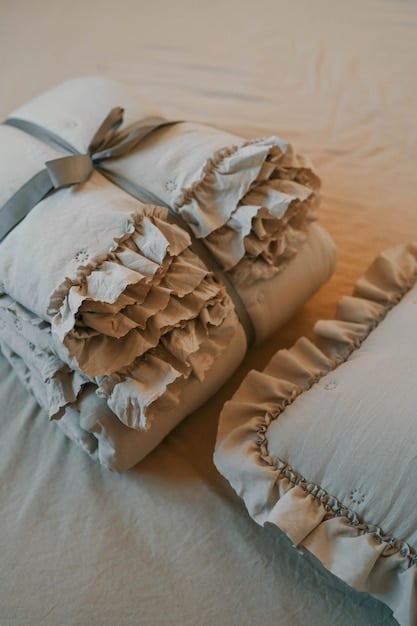 A close-up of H&M Home bedding featuring a textured duvet cover and matching pillowcases. The image highlights the quality and detail of the fabric, and is relevant to H&M Home decor.
