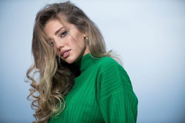Close-up shot of a woman with long, wavy hair styled in a half-up, half-down look secured with a decorative, minimalist claw clip. The focus is on the clip's design and how it complements the hairstyle, hinting at the potential longevity of the claw clip trend. The image illustrates Are claw clips still the go-to hair accessory in 2025, or is there a new favorite?
