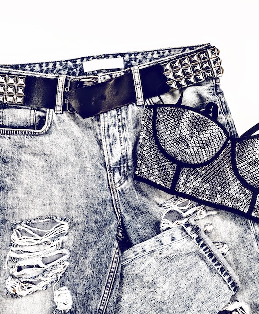 A collage of different vintage denim styles: high-waisted acid wash jeans, a faded black denim jacket with pins, and colored denim overalls in pastel pink, showing the range of The comeback of vintage denim: How are people styling it in 2025?.