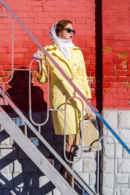 A street-style shot of a person wearing an oversized blazer with a unique print, paired with wide-leg trousers and chunky boots. The setting is a bustling city street, and the overall vibe is edgy and fashionable.