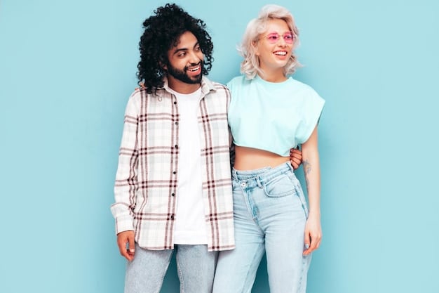 Two individuals, one male and one female, wearing the same gender-neutral outfit in different colors, showcasing the versatility and appeal of the clothing. They are standing in a modern, minimalist studio space, highlighting the fashion-forward nature of the trend, will the demand for gender-neutral clothing increase by 25% in 2025?, with universal design principles.