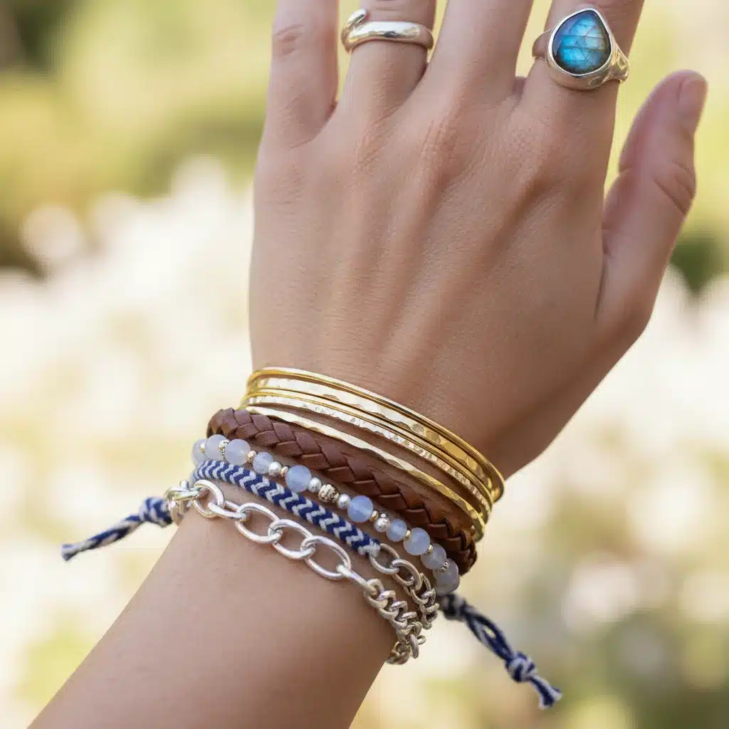 Close-up of layered bracelets and rings on a hand, showcasing jewelry styling